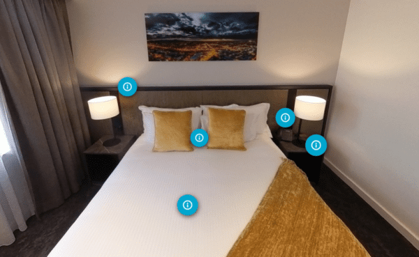 An image of a hotel room bed in the Immersive Learning course